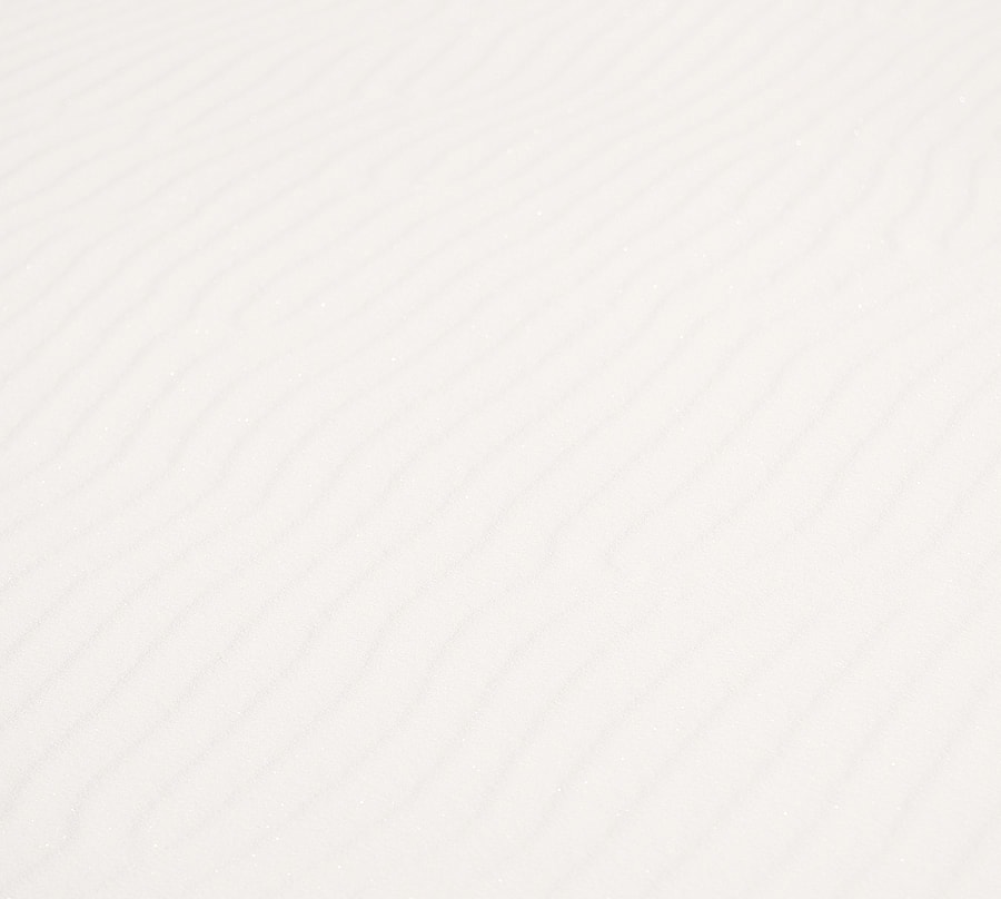 Textured white sand with subtle ripple patterns