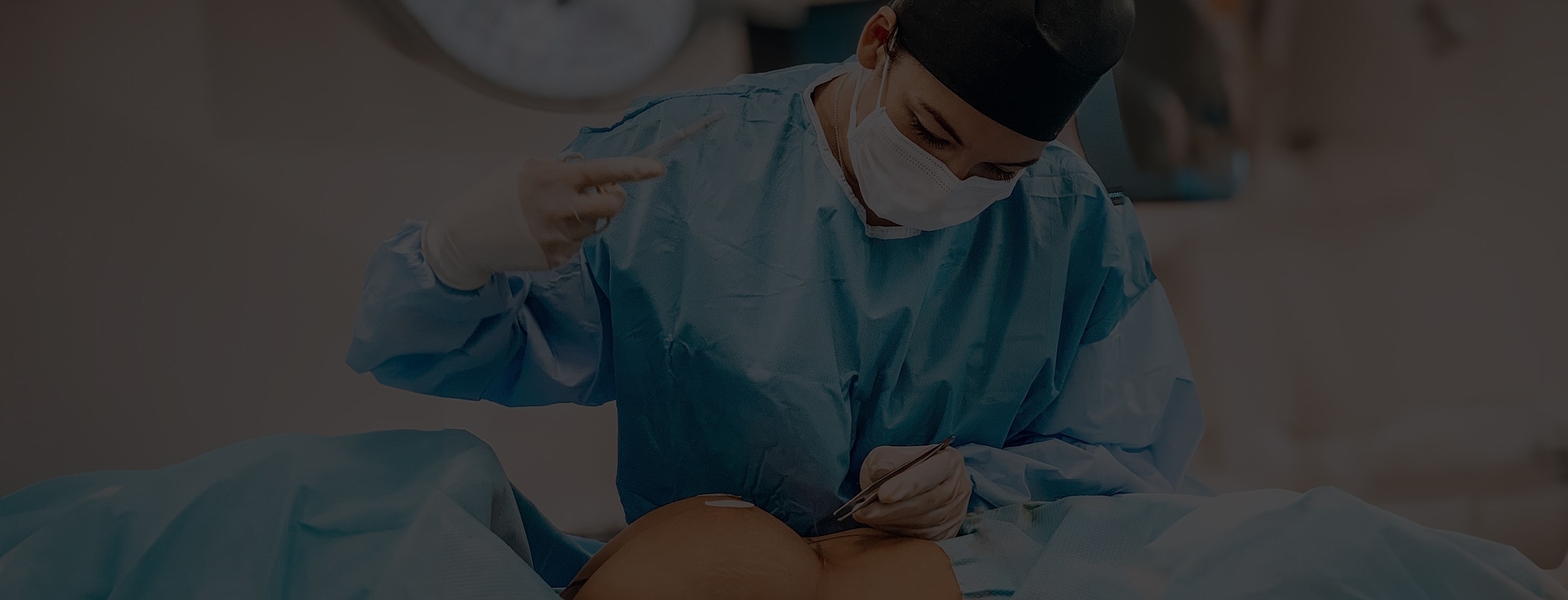 Surgeon performing procedure in sterile environment.